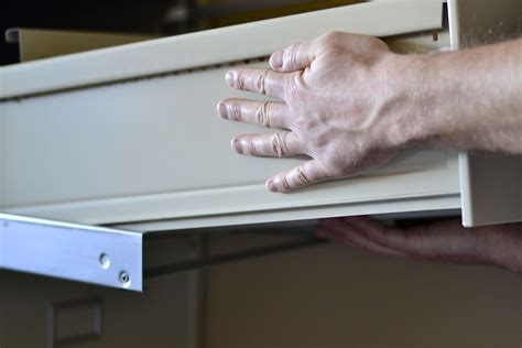 how to remove drawers from steel file cabinet|remove cabinet drawer lock brackets.